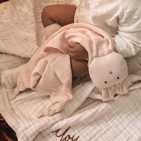 Baby snuggled with pink bunny security blanket — Baby collection at Simply Serenity