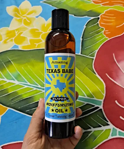 Bottle of Texas Babe Super Moisturizing Oil, a plant-based body oil that leaves skin soft, hydrated, and glowing